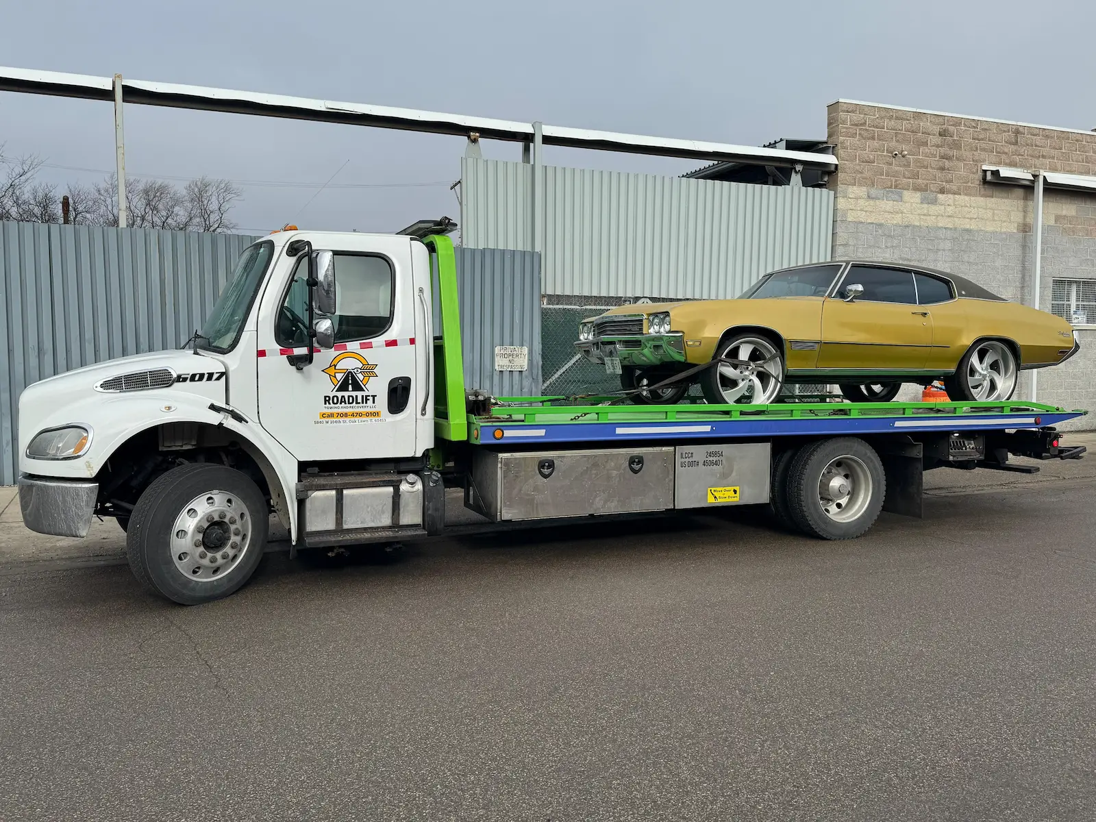 Flatbed towing classic car in Chicago suburbs using RoadLift Towing & Recovery