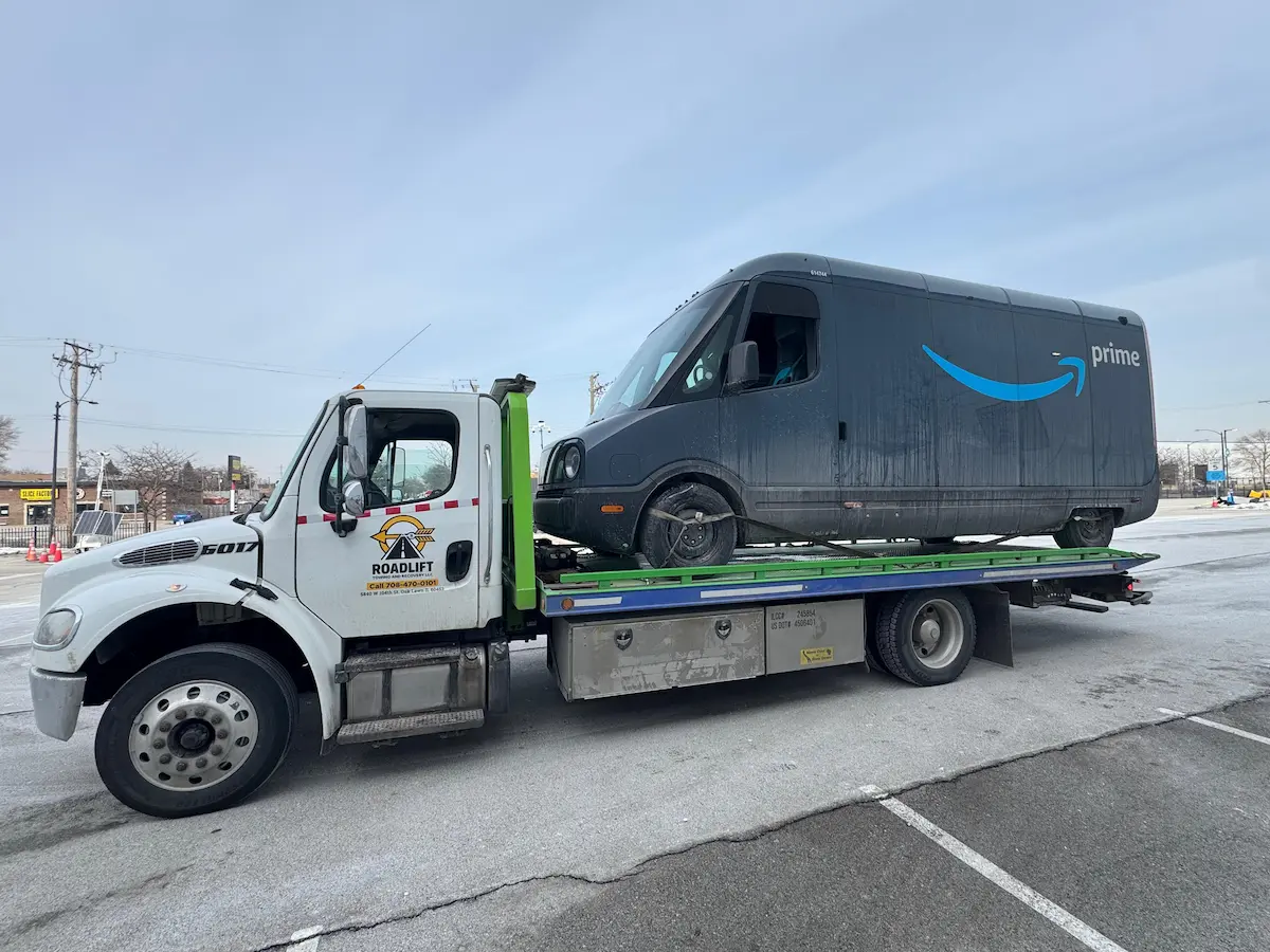 Flatbed towing service in Oak Lawn IL transporting an Amazon delivery van safely